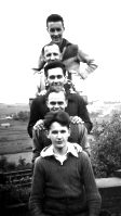 Four workers posing for a formal photograph